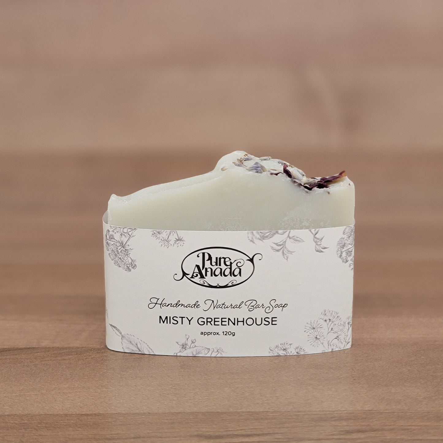 Bar of soap with a label on a wooden surface