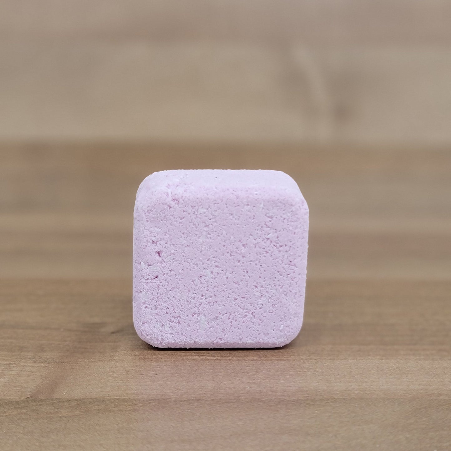 Purple square tablet on a wooden surface