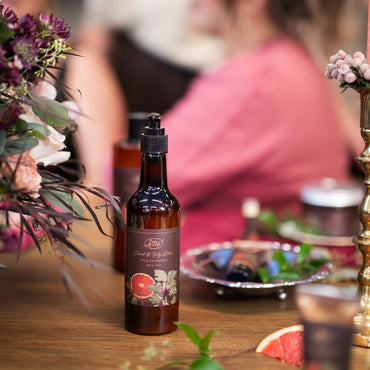 Bottle of beer on a table with blurred people in the background