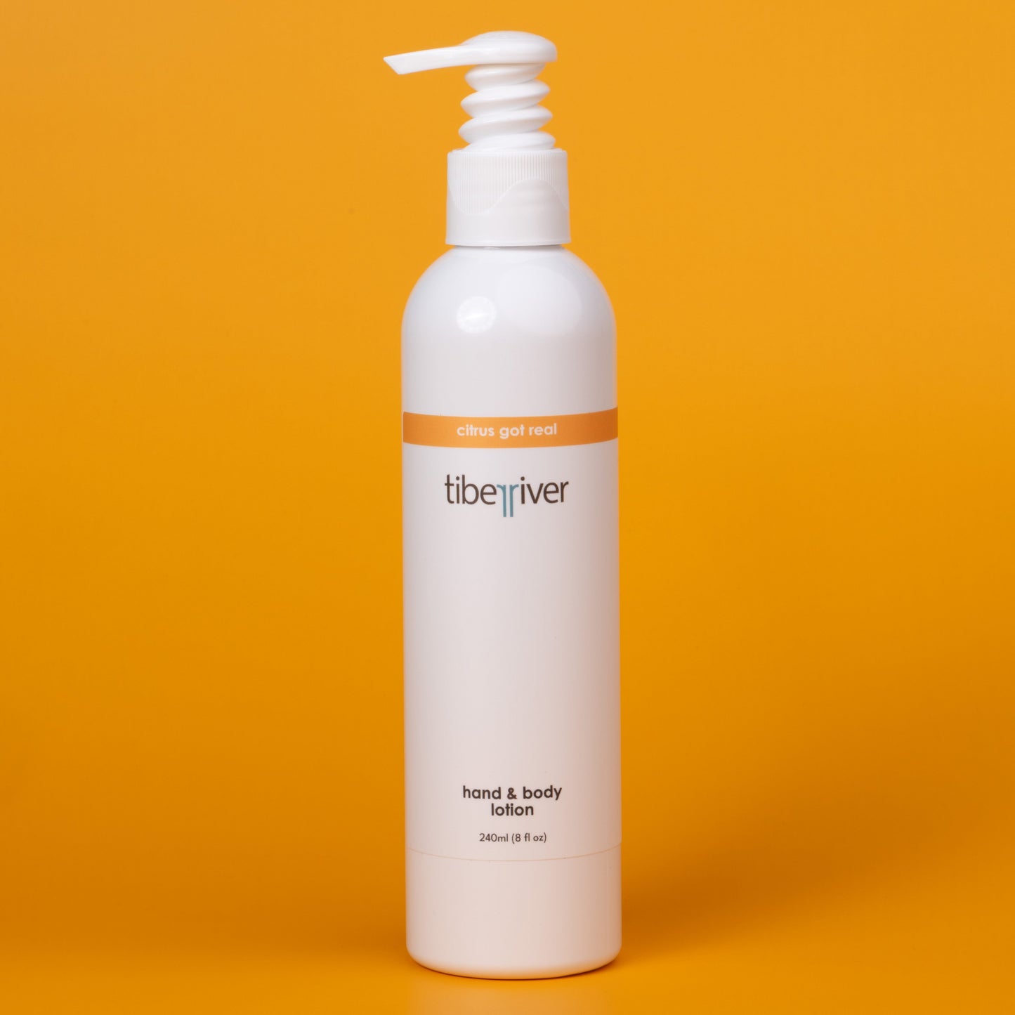White lotion bottle with pump on an orange background