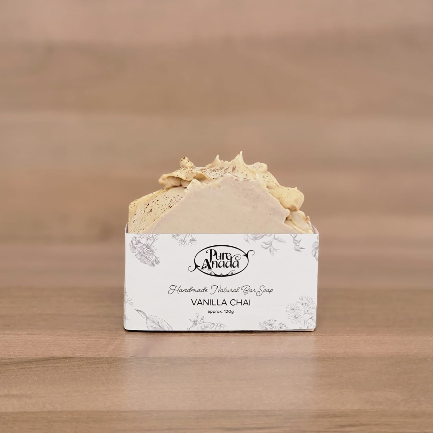 Bar of soap in a white box with 'Pura Vida' branding on a wooden surface