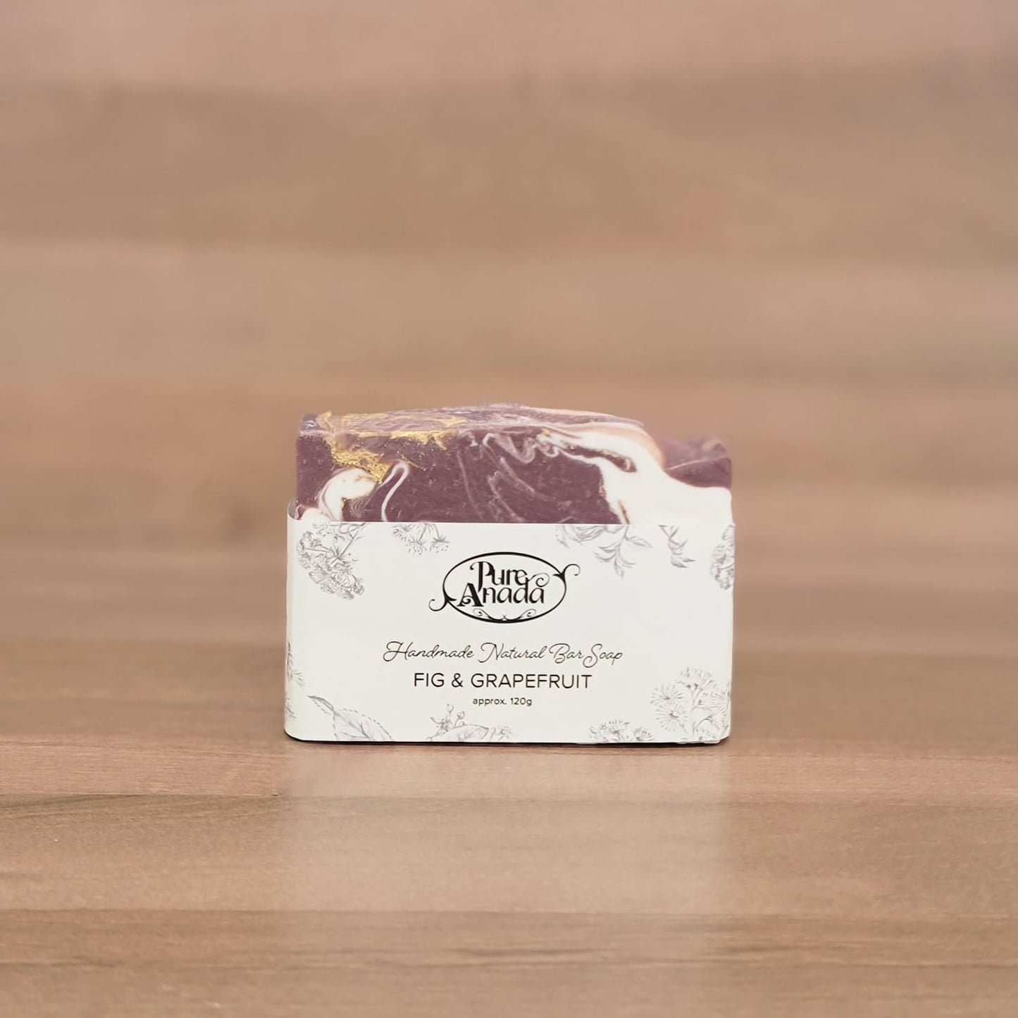 Bar of soap with a decorative label on a wooden surface