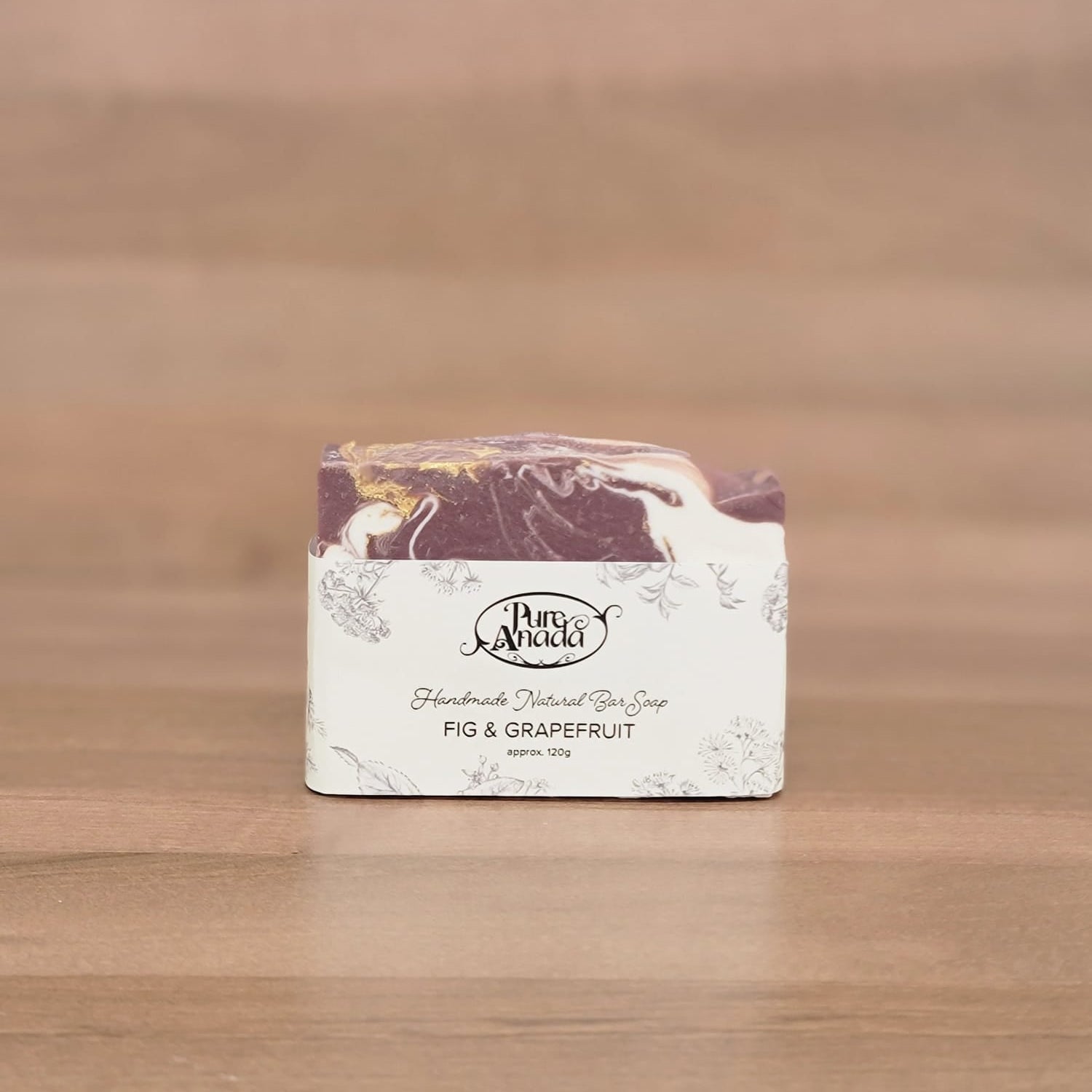 Bar of soap with a decorative label on a wooden surface