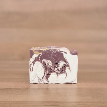 Marbled soap bar on a wooden surface with a blurred background