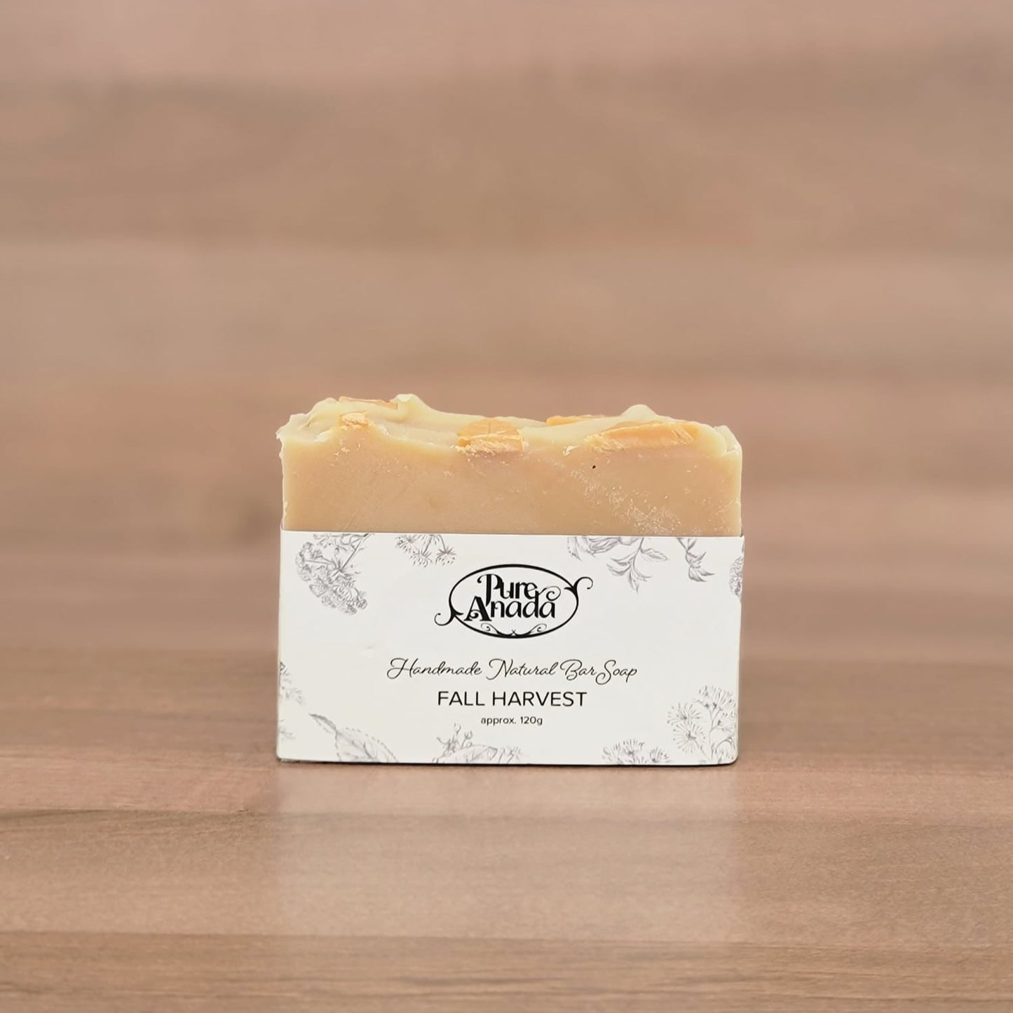 Bar of soap with a label on a wooden surface