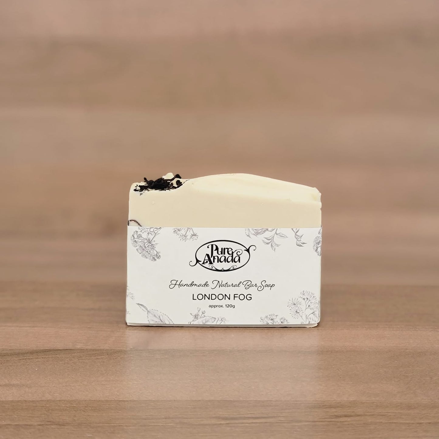 Bar of soap with a label on a wooden surface