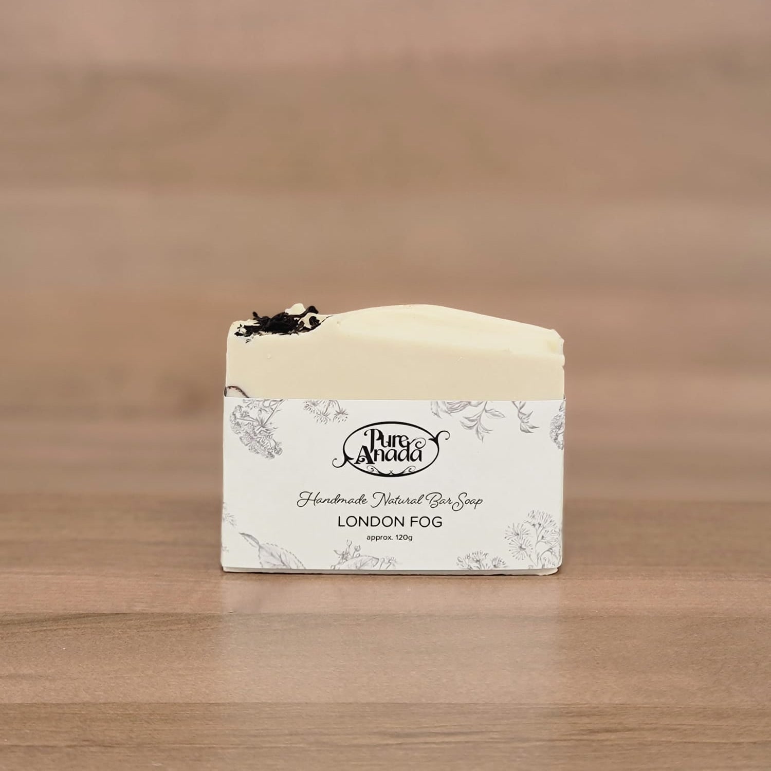 Bar of soap with a label on a wooden surface