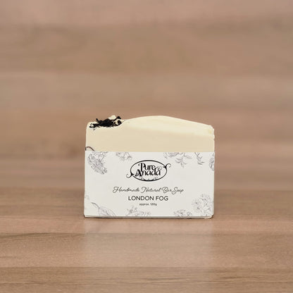 Bar of soap with a label on a wooden surface