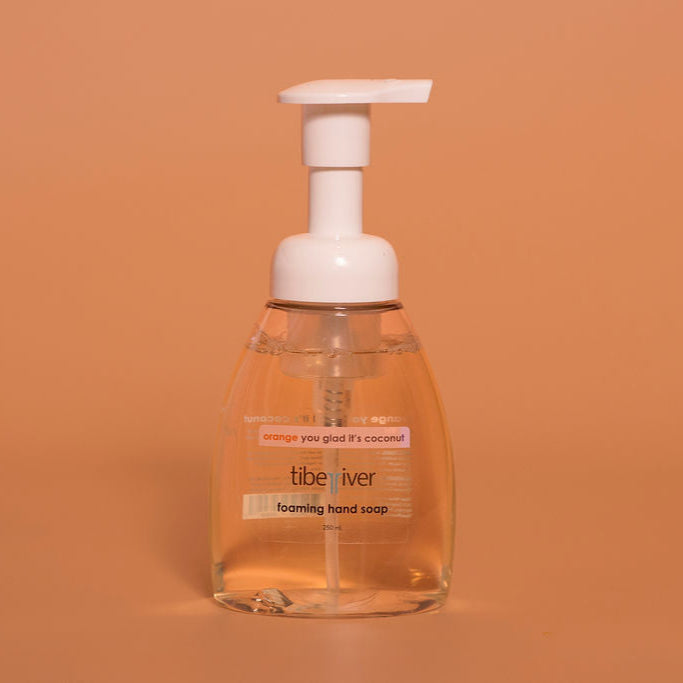Foaming hand soap bottle with pump on a brown background