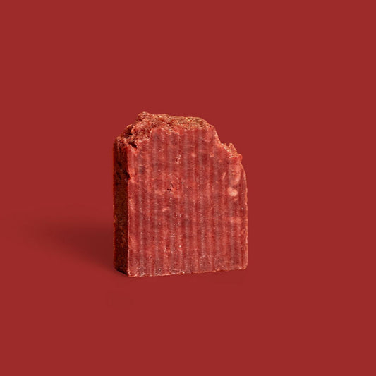red rectangular bar of soap on a red background