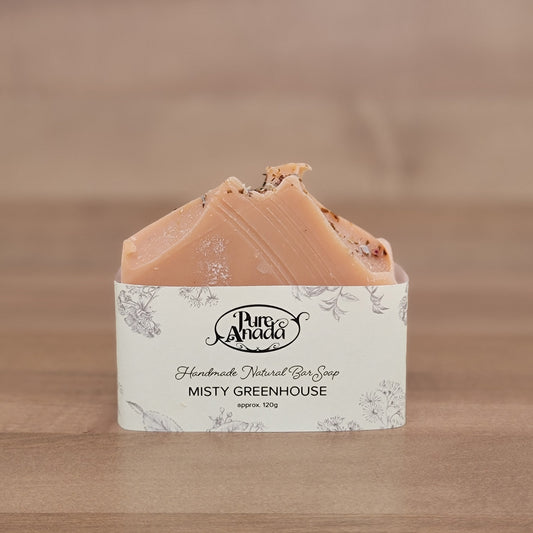 Bar of soap with a decorative Pure Anada label on a wooden surface