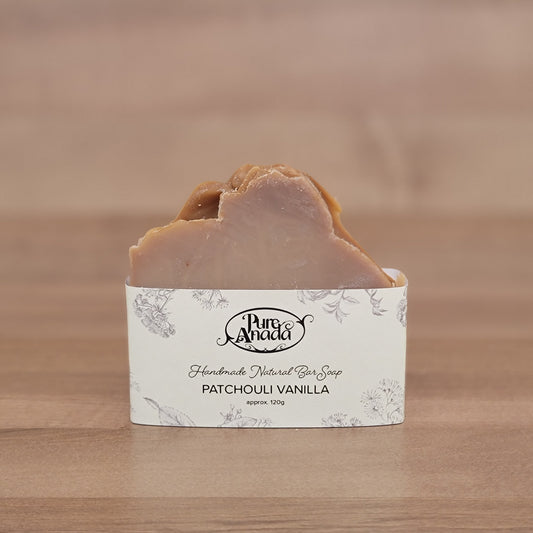 Bar of handmade soap with a label on a wooden surface