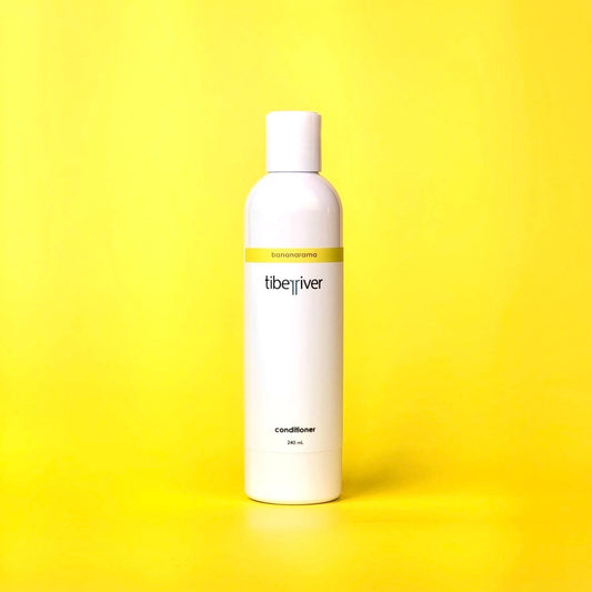 White bottle of Libe River conditioner on a yellow background