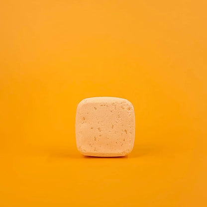 Square bar of soap on a gradient orange background