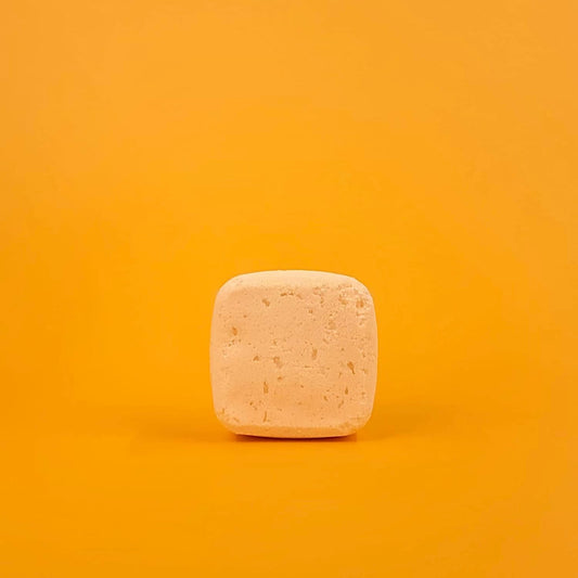 Square bar of soap on a gradient orange background
