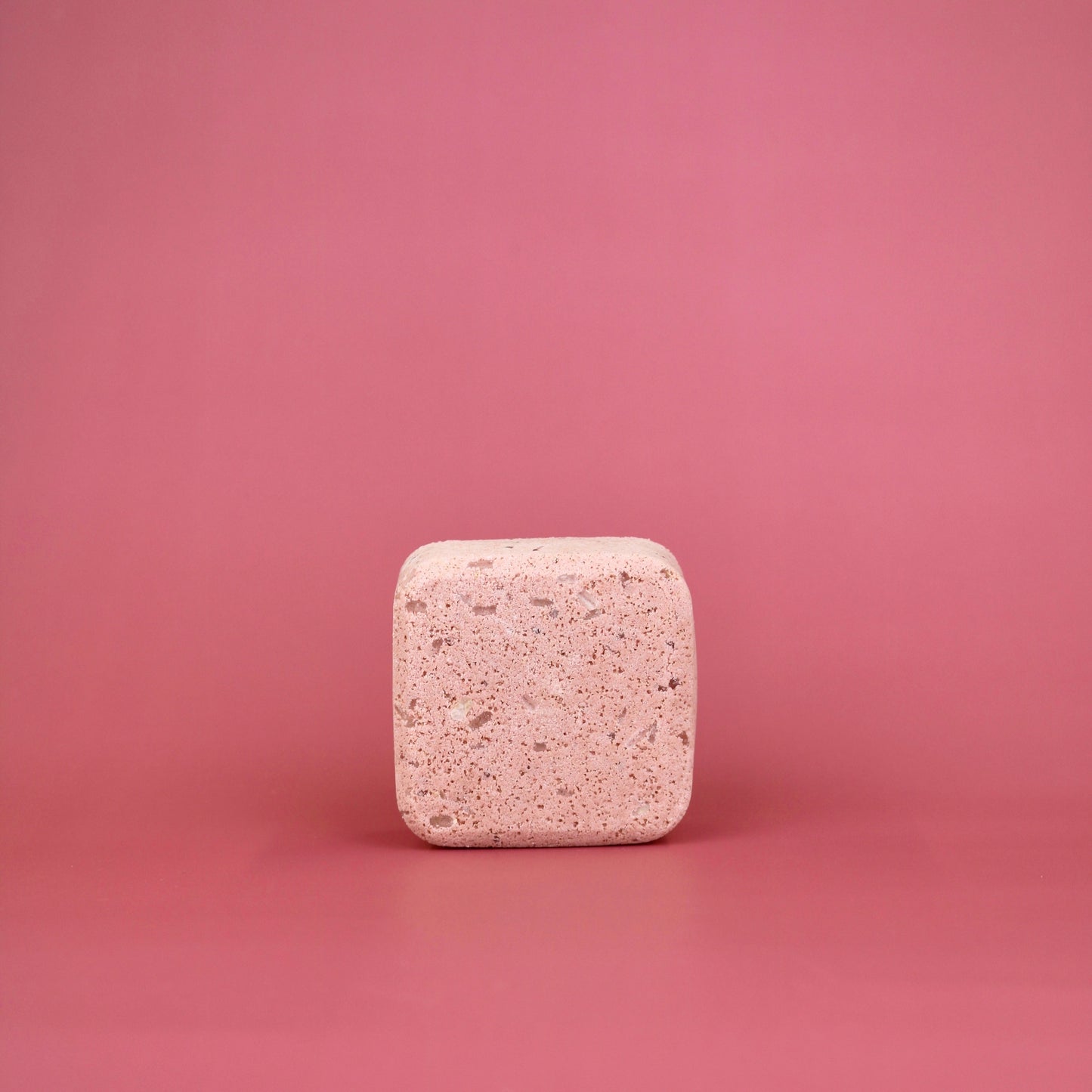 Square pink tablet on a pink background