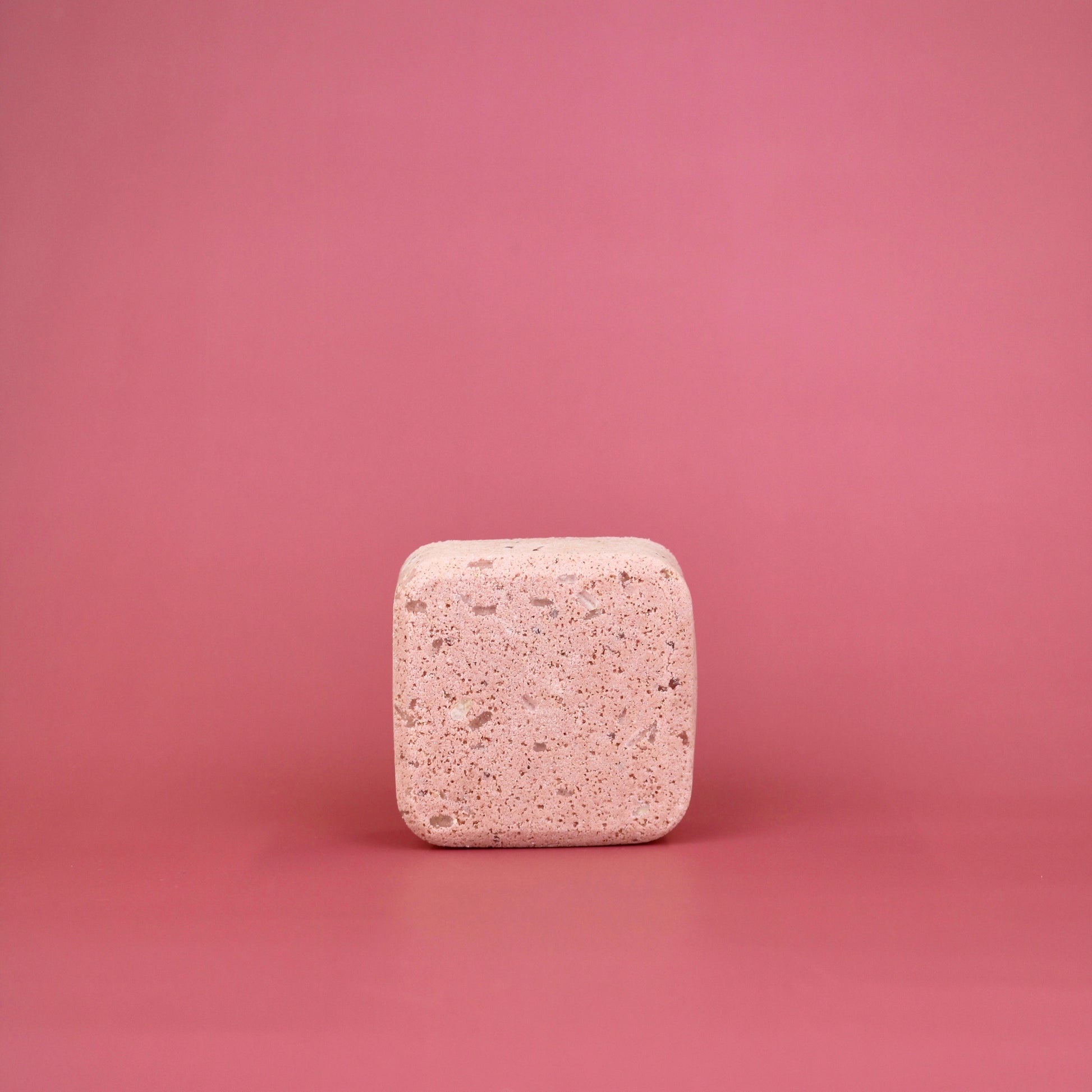 Square pink tablet on a pink background