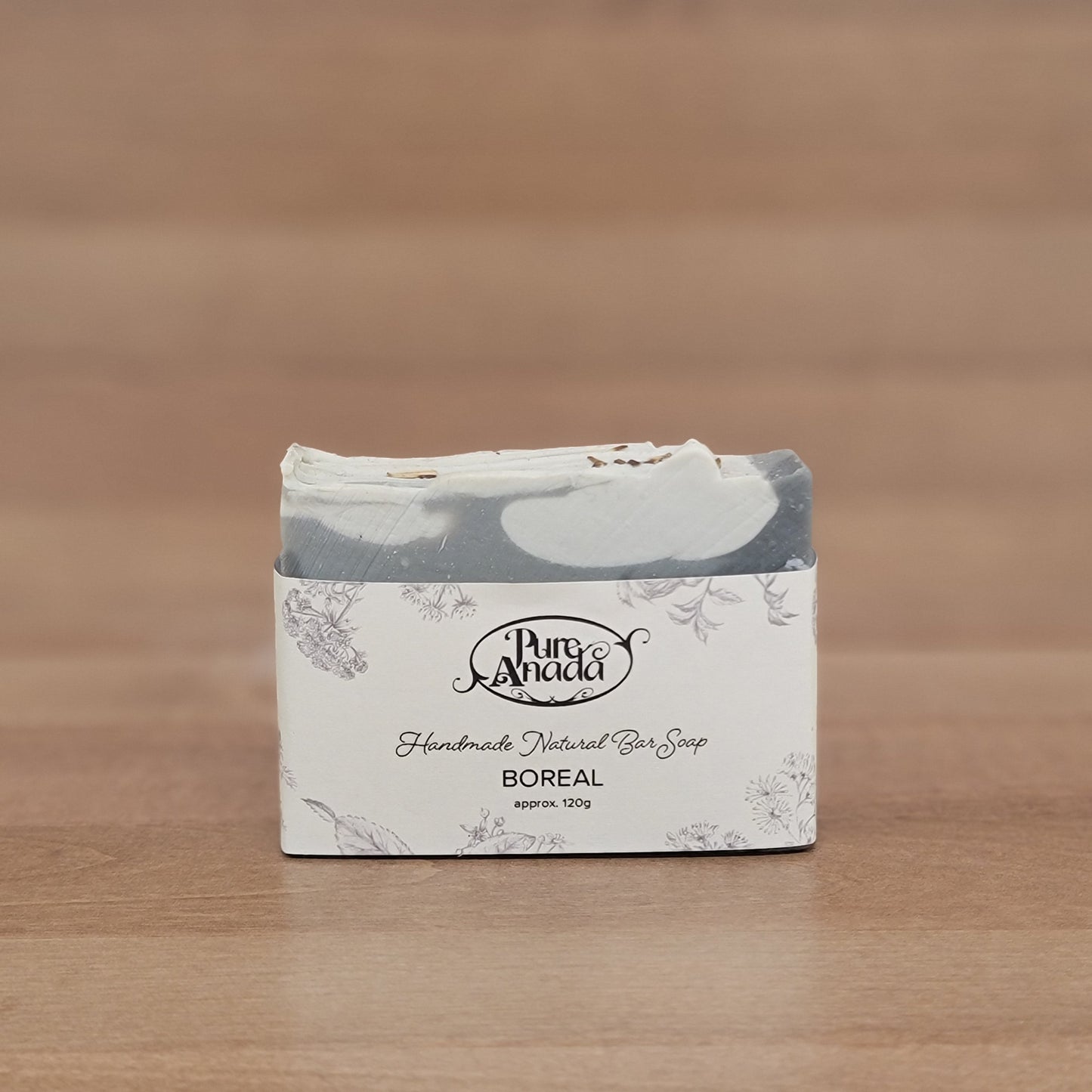 Product packaging with a brand logo on a wooden surface