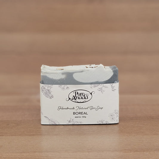 Product packaging with a brand logo on a wooden surface